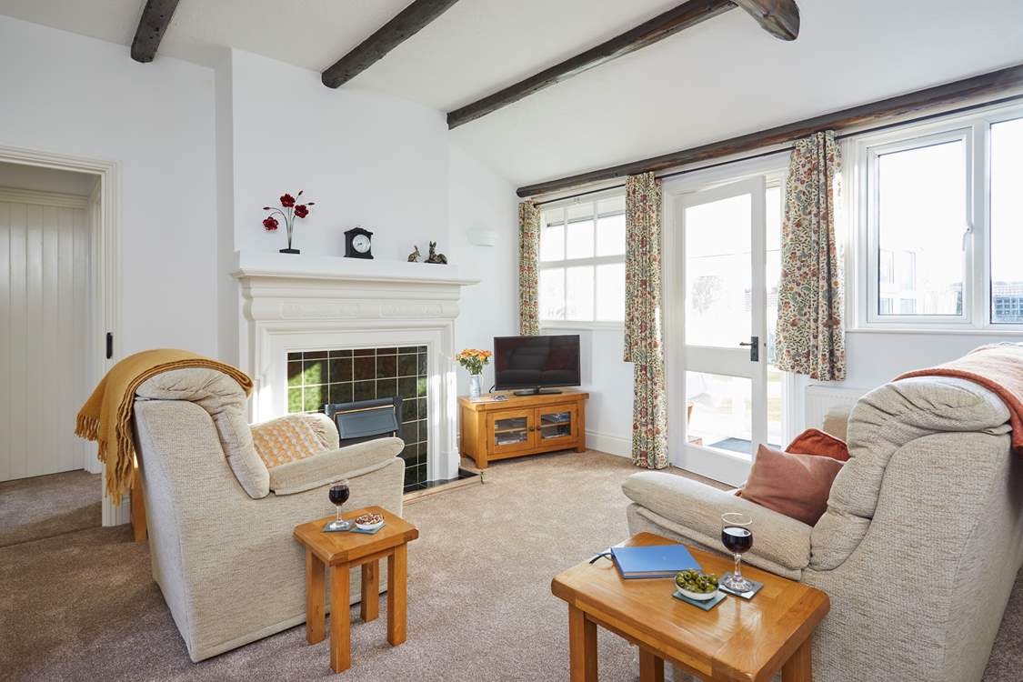 The spacious living room area leads on to the sun-room and garden.