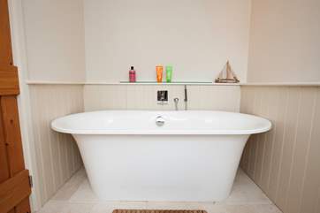 The lovely family bathroom on the first floor has a large bath, ideal for a relaxing soak.