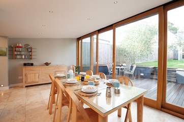 The dining-room leads out to a lovely decked patio and garden.