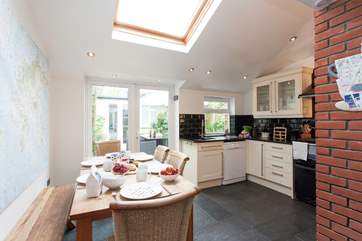 The bright, well-equipped kitchen/dining room leads on to an enclosed patio.