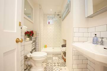 The beautifully appointed bathroom on the first floor offers an inviting luxury shower.