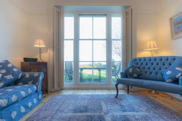 The sitting-room is full of light and charm.