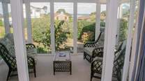 Lovely light and sunny conservatory with garden and sea views.