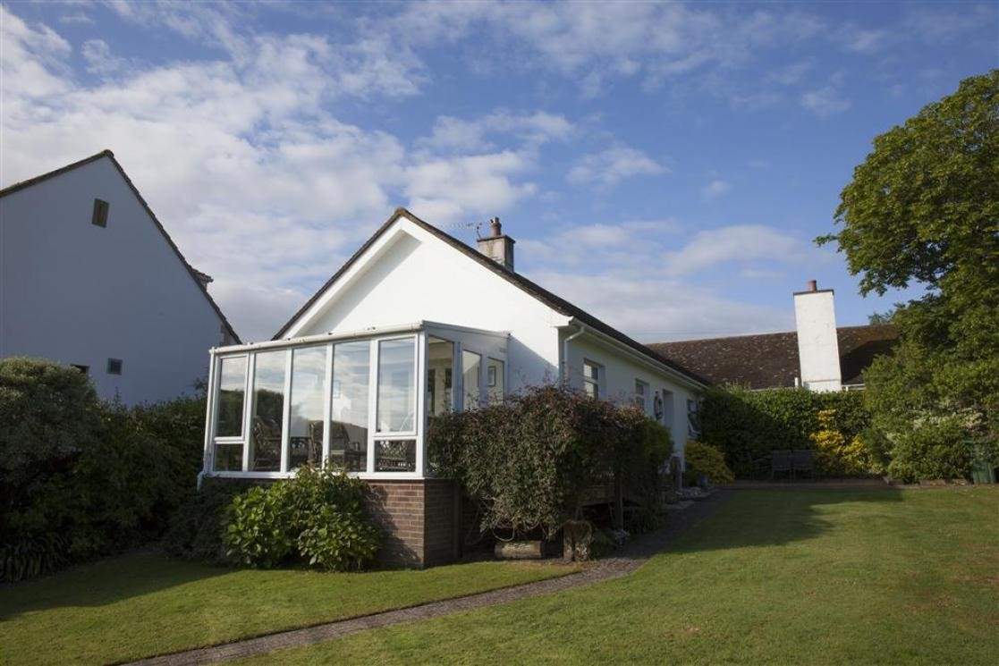 Sunny fully-enclosed garden at the front of the property.