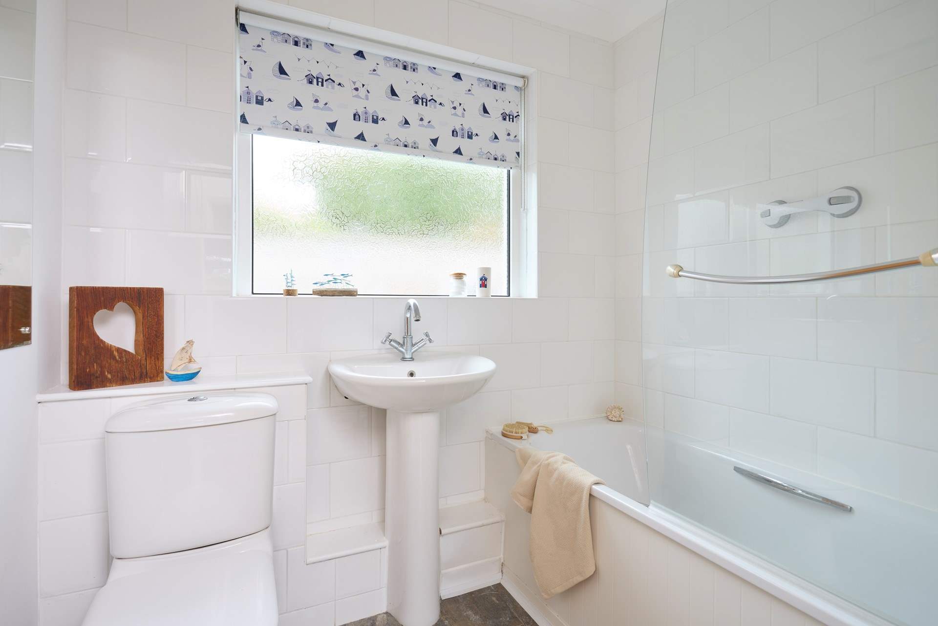 The family bathroom with bath and fitted shower.