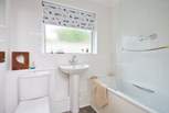 The family bathroom with bath and fitted shower.