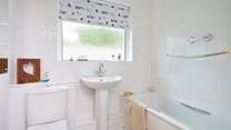 The family bathroom with bath and fitted shower.