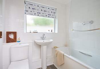The family bathroom with bath and fitted shower.