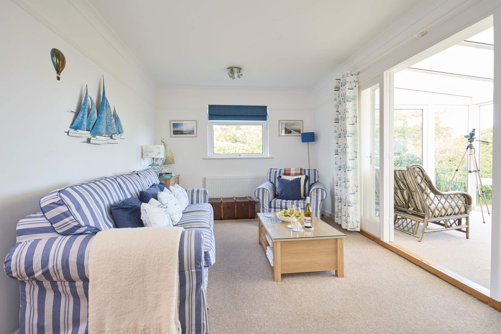 The comfortable sitting-room with doors into the sunny conservatory, a peaceful place to sit back and relax.