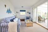 The comfortable sitting-room with doors into the sunny conservatory, a peaceful place to sit back and relax.