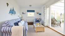 The comfortable sitting-room with doors into the sunny conservatory, a peaceful place to sit back and relax.