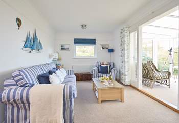 The comfortable sitting-room with doors into the sunny conservatory, a peaceful place to sit back and relax.