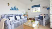 The open plan sitting/dining area leads to the conservatory and garden beyond.