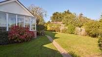 Sunny fully-enclosed garden at the front of the property.