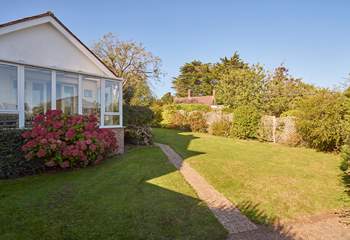 Sunny fully-enclosed garden at the front of the property.