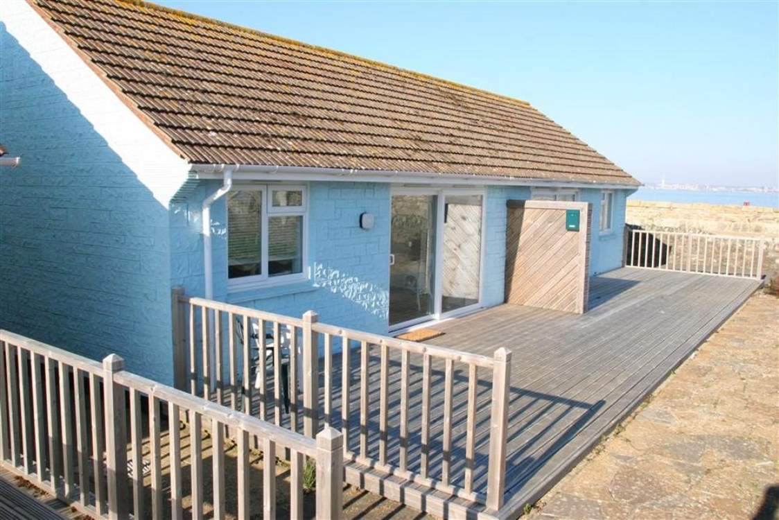 This compact bungalow is just steps from the sea.