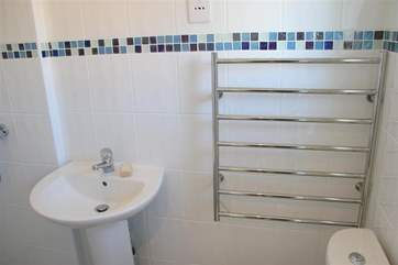 The bathroom features a modern walk-in shower.