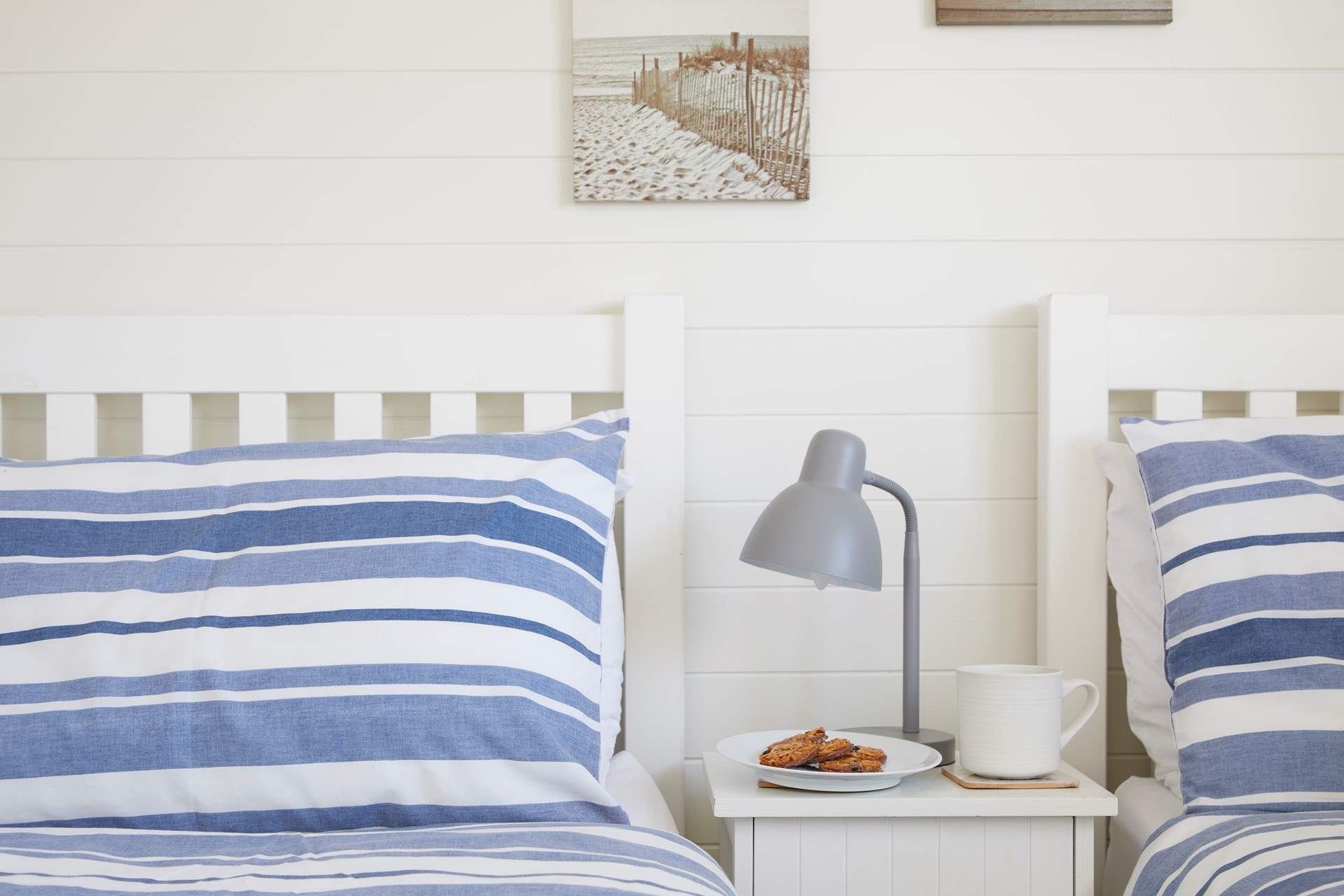 The twin bedroom is decorated in seaside colours. 