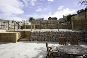 Fully enclosed patio with two levels of garden, which includes a petanque court