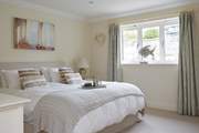 The spacious main bedroom on the first floor overlooks the garden. 