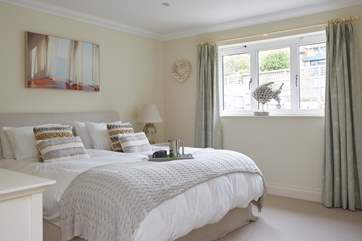 The spacious main bedroom on the first floor overlooks the garden.