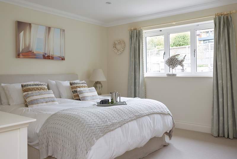 The spacious main bedroom on the first floor overlooks the garden. 