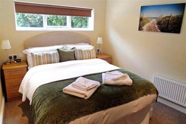 The mezzanine bedroom is reached by a set of stairs and there is a king-size and single bed.
