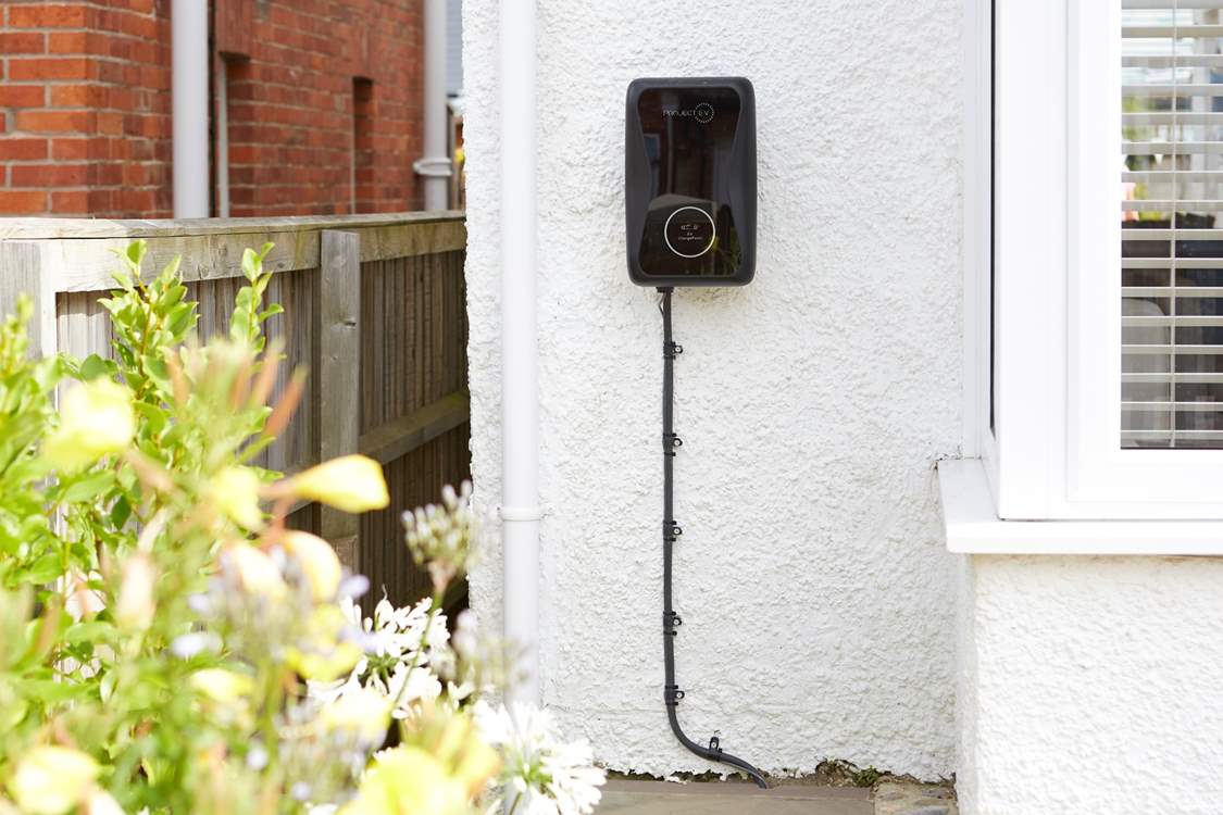 Electric car charger to the front of the house.