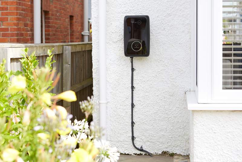 Electric car charger to the front of the house.