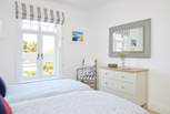 Natural light and a fresh decor in the twin room create this beautiful space. 