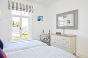 Natural light and a fresh decor in the twin room create this beautiful space.