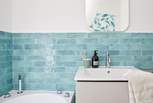 Fresh coastal style in the family bathroom. 
