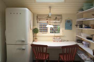 The table and chairs in the utility area are a perfect spot for children to be creative on a rainy day.