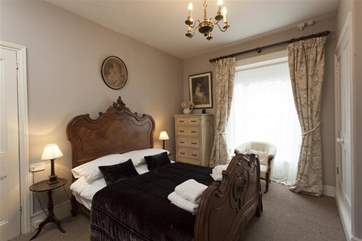 The grand double bedroom is both comfortable and inviting.