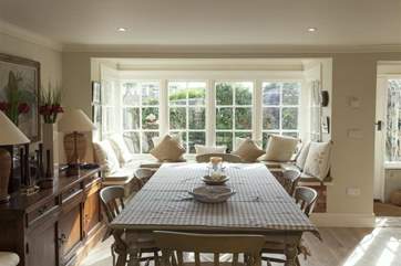 The table is next to the kitchen area.