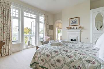 The double bedroom with balcony and en suite through the archway. Please note there is no door between the bedroom and bathroom.