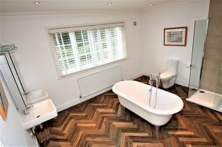 Relax and unwind in the en suite bathroom with roll-top bath