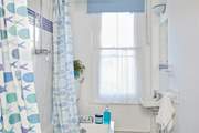 The family bathroom with bath and over head shower.