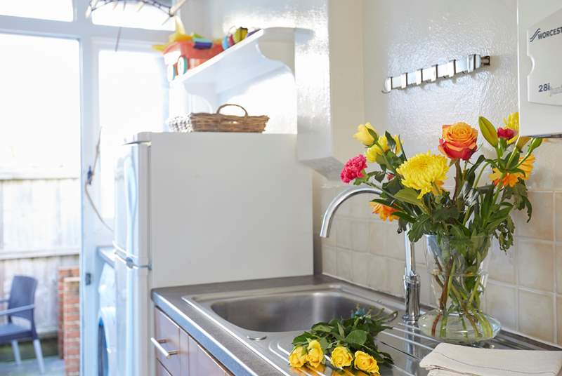 The galley utility is a continuation of the kitchen with access to the rear courtyard.