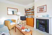 Plenty of room for the family in the sitting-room with television and a choice of reading material too.