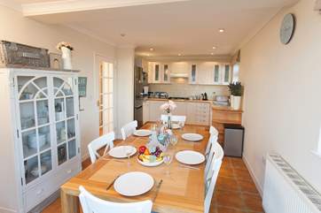 Open plan kitchen/dining-room with doors opening onto the front balcony.