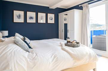 The comfortable main bedroom with balcony.