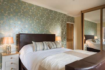 The master bedroom en suite with super king bed with a hidden TV.