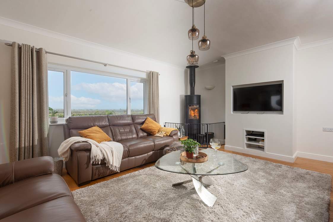 The sitting room boasts an enormous log burner.