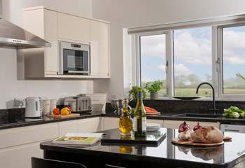 The kitchen has an island, bar stools and a lovely countryside outlook.