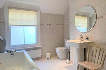 The family bathroom is both spacious and modern.
