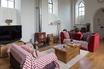 This wonderful open plan sitting-room has a cosy wood-burner for cooler evenings.