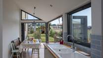 The dining-area has bi-fold and tri-fold doors, that open to bring the outside in.