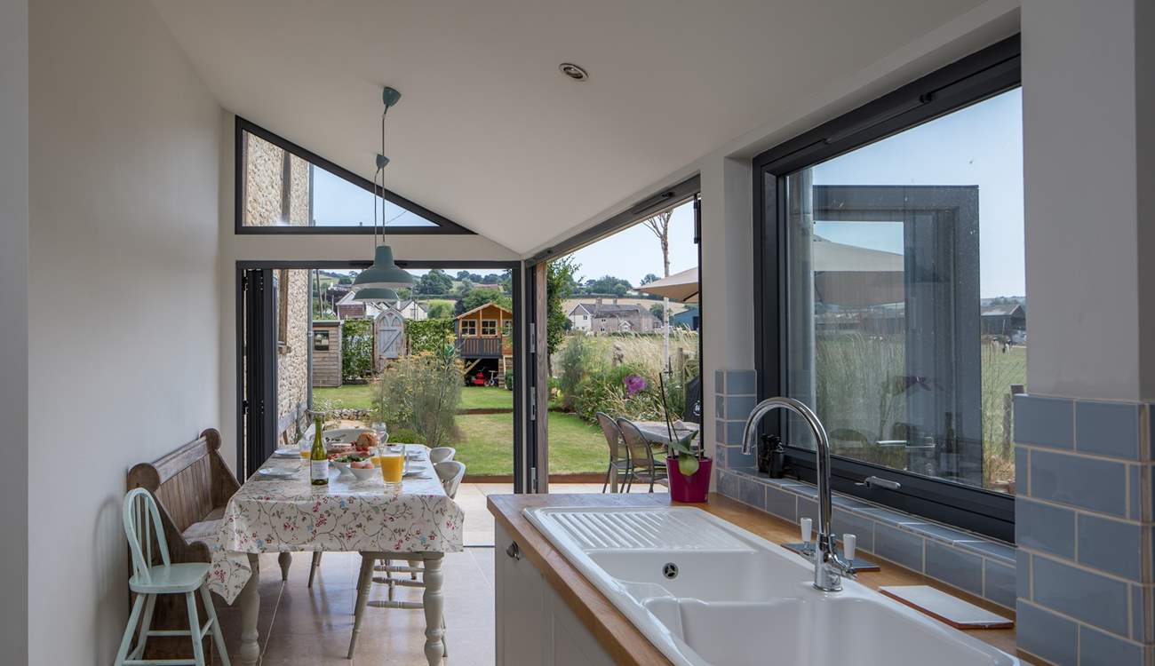 The dining-area has bi-fold and tri-fold doors, that open to bring the outside in.