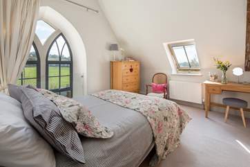 The master bedroom has this beautiful feature window, protected by a glass safety screen.